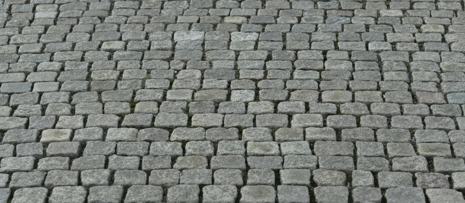 Pilkų granito trinkelių grindinys, trinkelės sudėtos lygiomis eilėmis